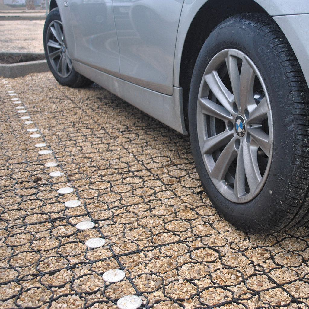 tildapave with stones in and a car parked on top