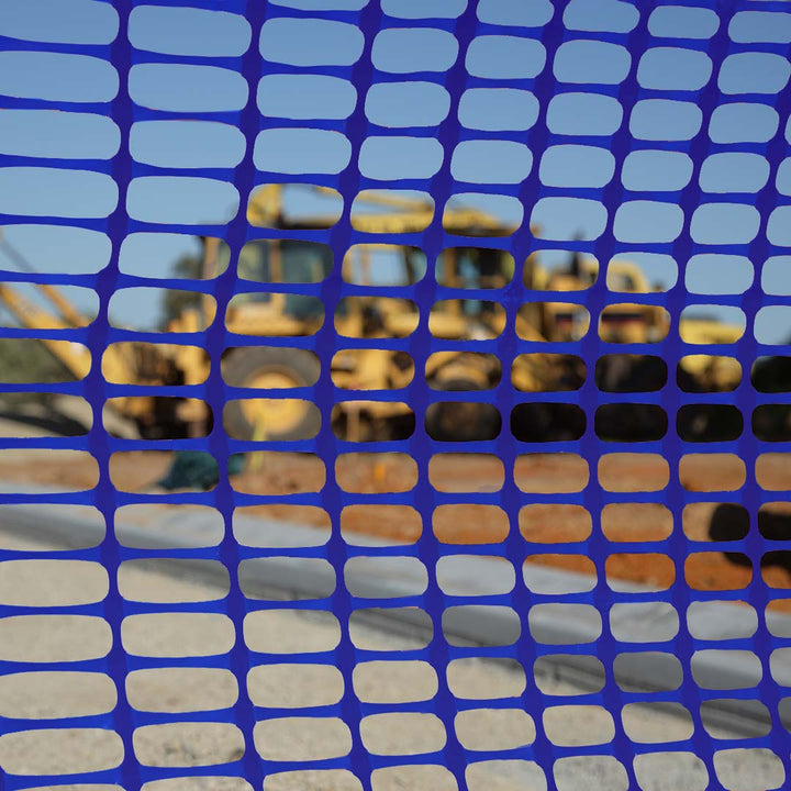 Close up view through blue barrier mesh on-site