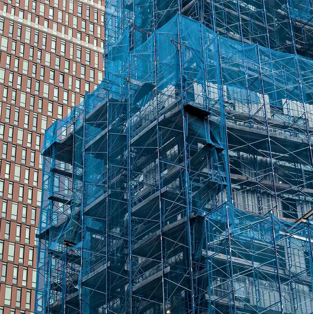 blue debris netting around a building