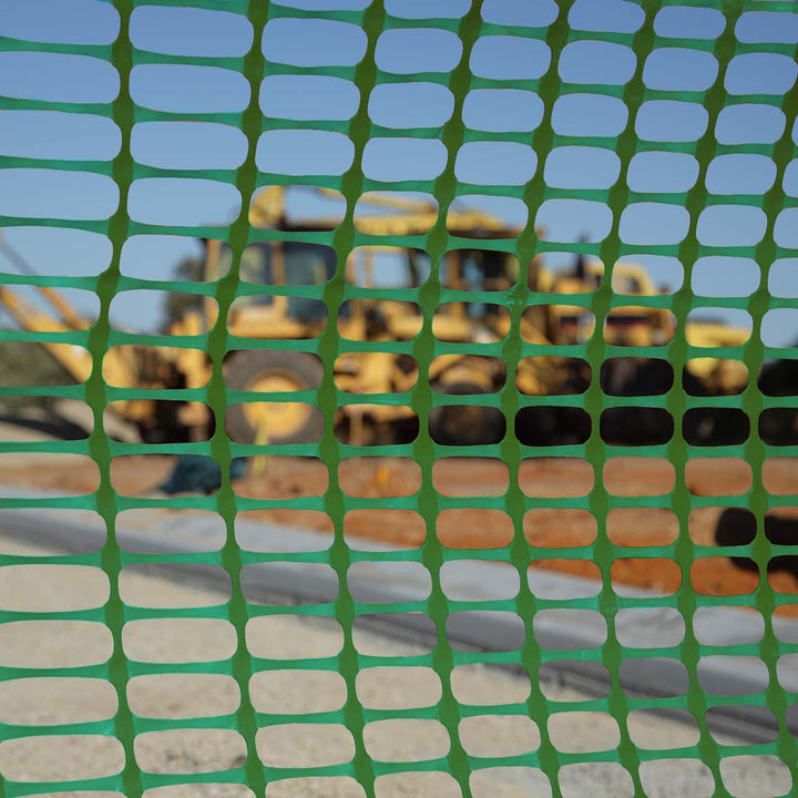 Close up view through green barrier mesh on-site