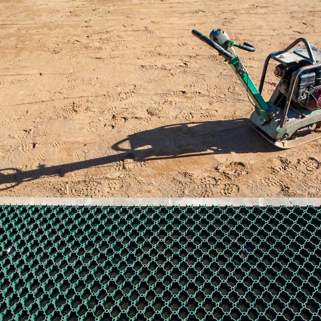 Construction tool on a sandy surface with a grid pattern in the foreground