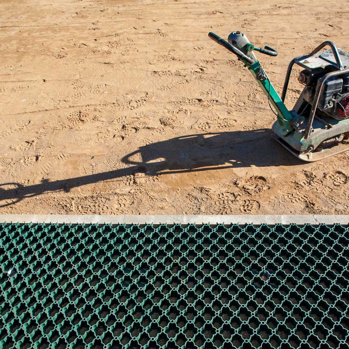 Construction tool on a sandy surface with a grid pattern in the foreground