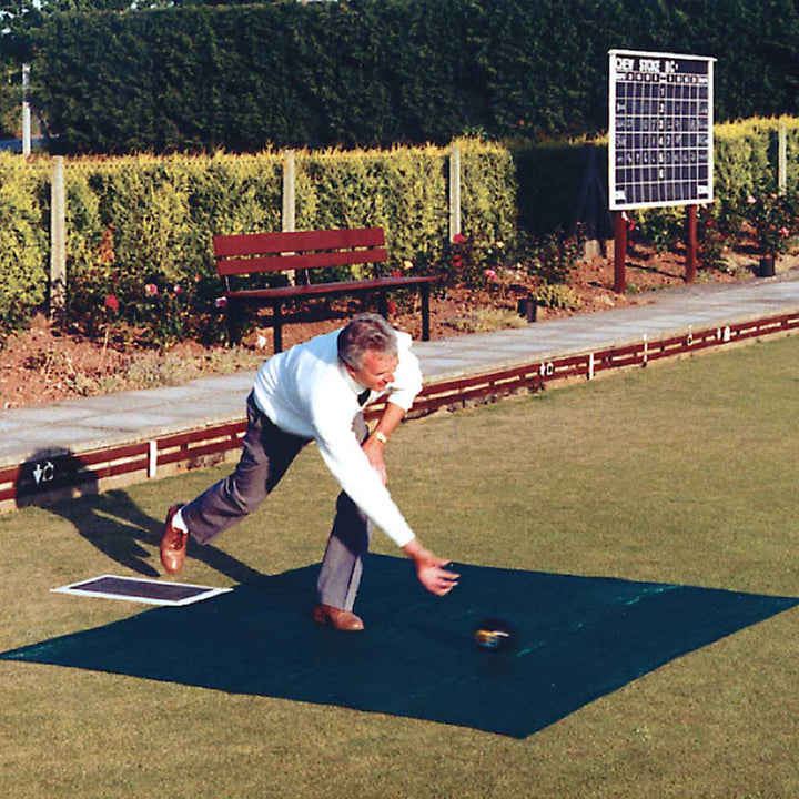 Man rolling ball on protection mat