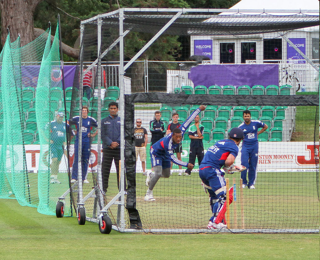 cricket ball stop net with cricket players on field