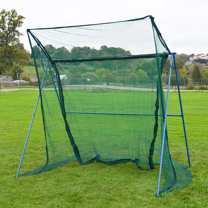 Portable batting cage on a grassy field with trees in the background