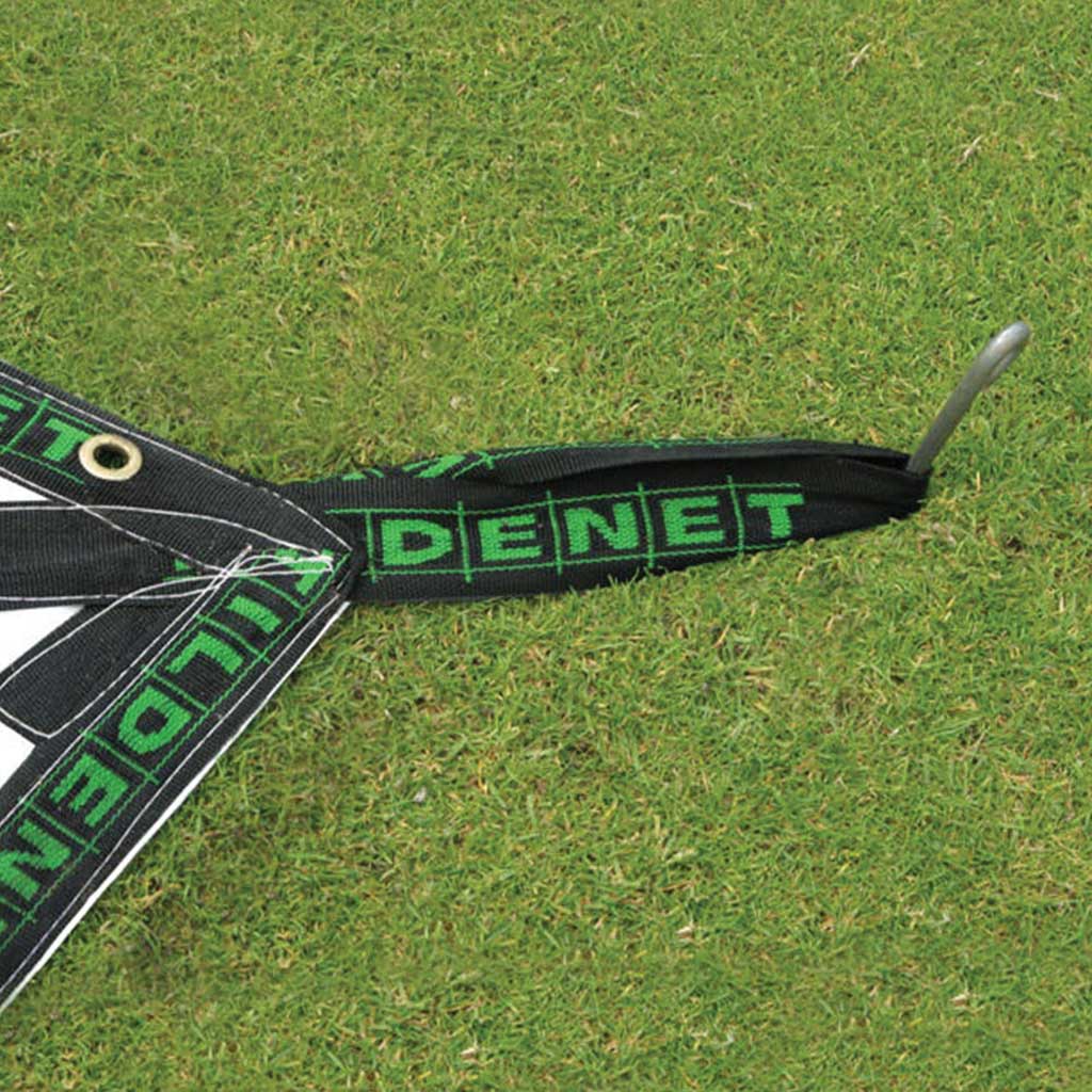 close up of lay flat rain cover fixing loop displaying Tildenet with a peg securing it to grass