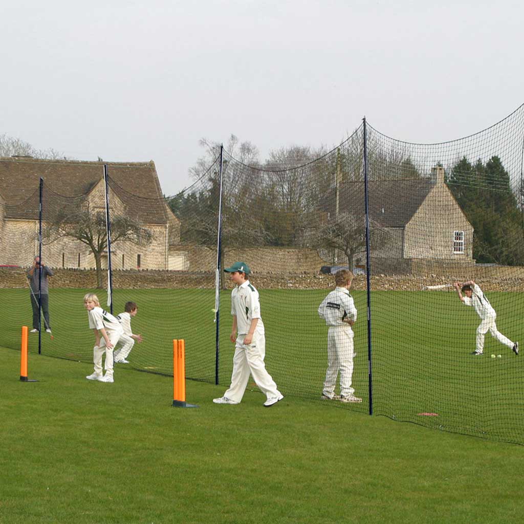 youth cricketers playing cricket with portanets in place