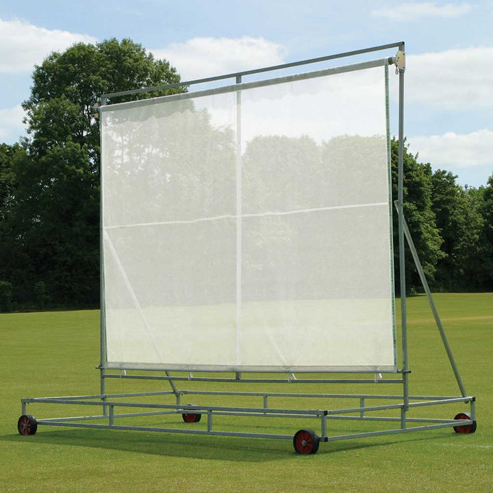 screen attached to a metal frame on grass with trees in the background