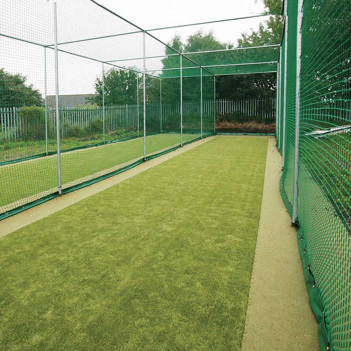 small cricket bay playing area surrounded by green netting