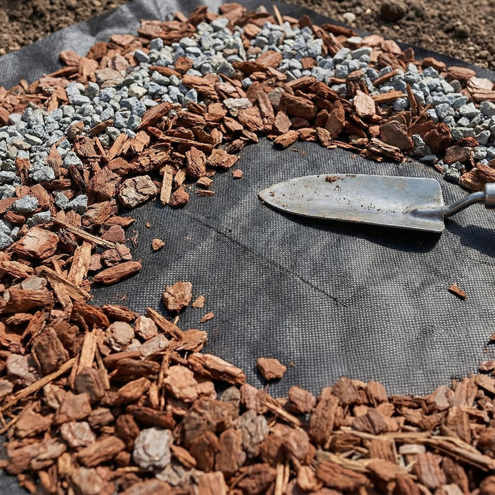 Weedban landscape fabric beneath a bed of wood chippings and gravel
