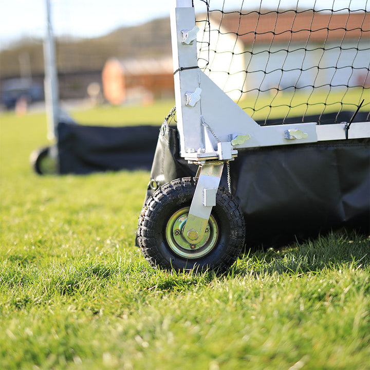 close up of black wheel on mobile cricket cage