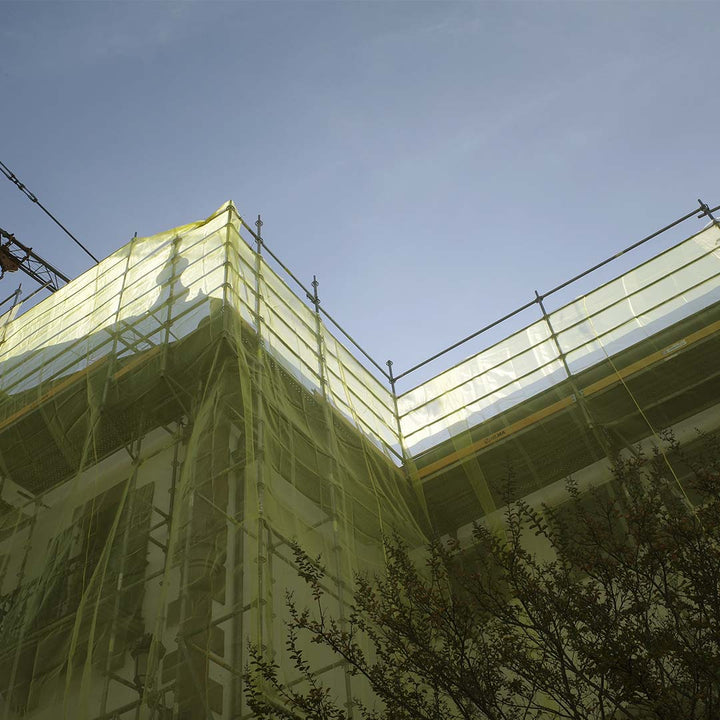 yellow debri netting around a building